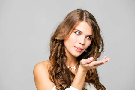 Beauty portrait of young attractive woman, isolated on gray
