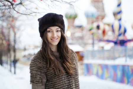 Young beautiful woman in stylish mink coat on a background of a winter streetの写真素材