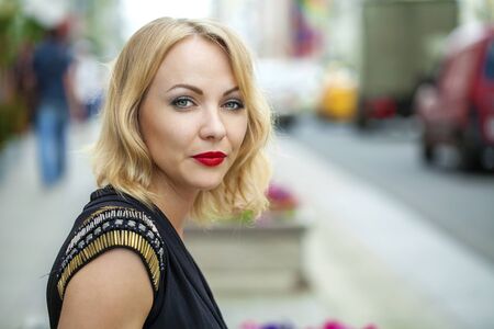 Close up Portrait, Young beautiful blonde woman posing outdoors in sunny weather