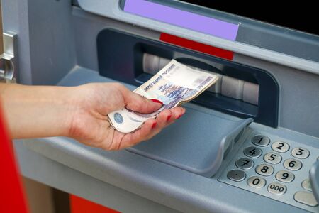 Female hands closeup with Russian rubles - woman withdraw money at cashpointsの写真素材