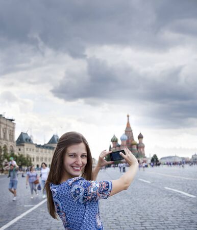 Happy young brunette woman photographed attractions in Moscowの写真素材