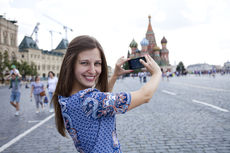 Happy young brunette woman photographed attractions in Moscowの写真素材