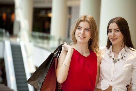 Close up, Two girlfriends with shopping bagsの写真素材