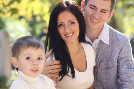 family with boy in autumn parkの写真素材