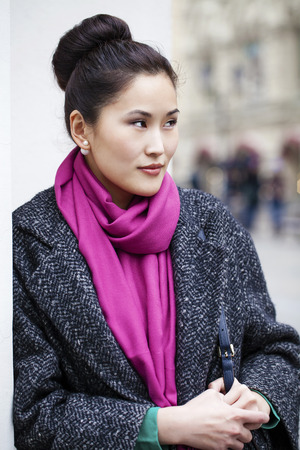 Asian beautiful woman in stylish gray coat on a background of spring streetの写真素材