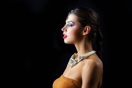 Close up portrait of beautiful eastern woman on a black backgroundの写真素材