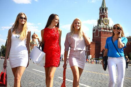 Happy shopping women walking at the red square in Moscowの写真素材