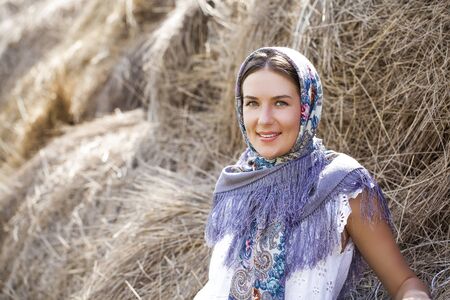 Portrait of young happy woman in blue scarfの写真素材