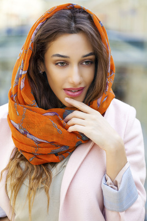 Close up portrait of a muslim young woman wearing a head scarf, indoorの写真素材