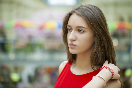 Portrait close up of young beautiful woman in red dressの写真素材