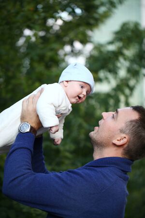Father and his baby boy  in autumn parkの写真素材