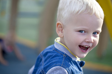 Portrait of blonde baby boy in summer parkの写真素材