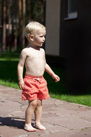 Portrait of blonde baby boy in summer parkの写真素材