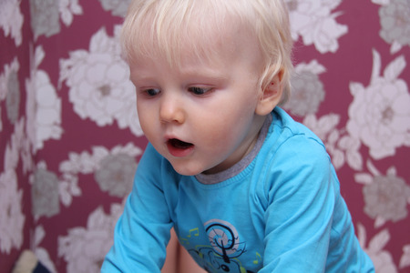 Portrait of blonde baby boy at homeの写真素材