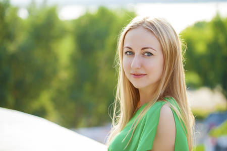 Close up Portrait, Young beautiful blonde woman posing outdoors in sunny weatherの写真素材