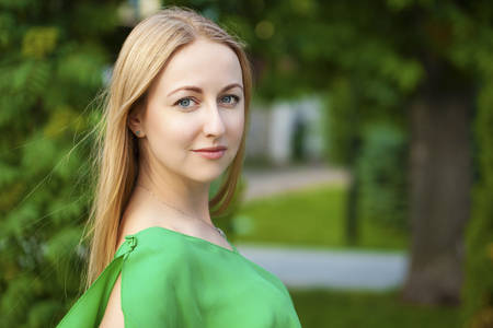 Close up Portrait, Young beautiful blonde woman posing outdoors in sunny weatherの写真素材