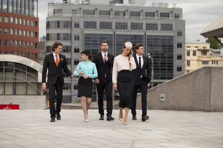 Business people are walking down the street on a background of business centersの写真素材