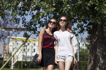 Two cheerful girls, summer street outdoorsの写真素材