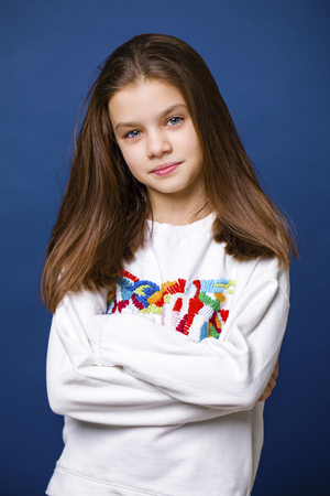 Young beautiful brunette woman in red dress, on studio wall backgroundの写真素材