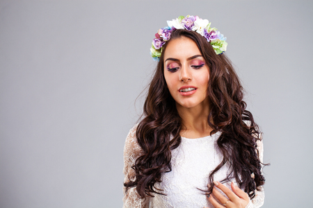 Close up face. Young arabic woman in white sexy dress, isolated on gray backgroundの写真素材