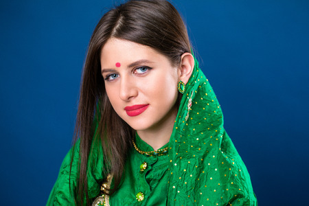 Close up portrait of beautiful eastern woman in green sariの写真素材
