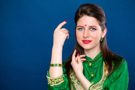 Close up portrait of beautiful eastern woman in green sari