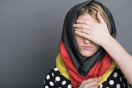 Grieving germanium, a young German woman covers her face handの写真素材