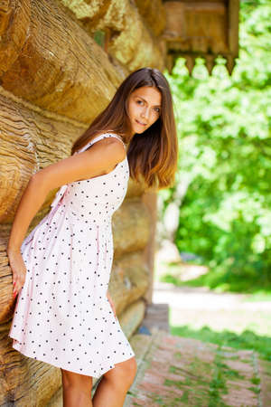 Portrait of a beautiful young woman on a background of old wooden wallの写真素材