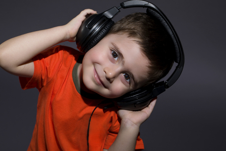 Cute Little Boy listening to music on headphonesの写真素材