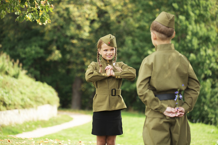 Long-awaited meeting. Two children in military uniforms of the Great Patriotic War. World War IIの写真素材