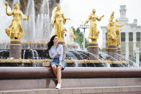 Young beautiful brunette girl listening to music on headphones, summer park outdoorsのeditorial素材