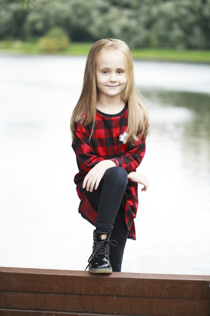 Portrait of a beautiful young blonde little girl, summer outdoorsの写真素材