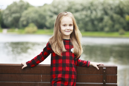 Portrait of a beautiful young blonde little girl, summer outdoorsの写真素材