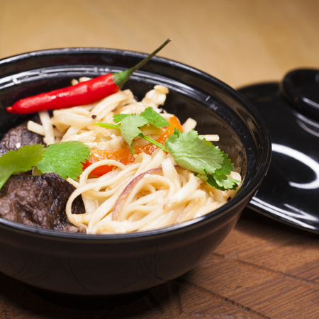 Asian cuisine, restaurant dish noodles with bits of beefの写真素材