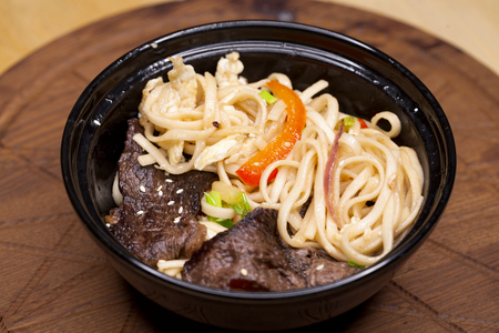 Asian cuisine, restaurant dish noodles with bits of beefの写真素材
