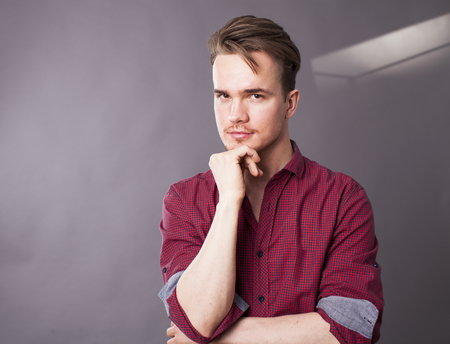 Studio portrait of a young man on a dark background