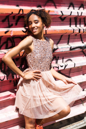 Street fashion model. Portrait of an African young woman in pink dressの写真素材