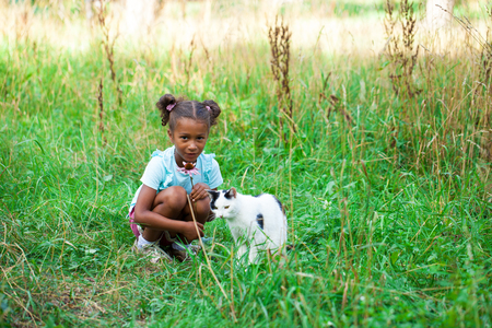Close up portrait of pretty mixed race African-American little girl, summer park outdoorsの写真素材