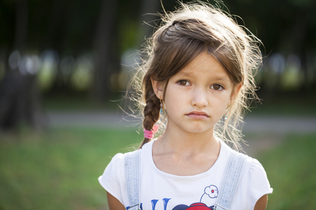Portrait of a beautiful young brunette little girl, summer outdoorsの写真素材