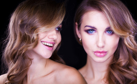 Close-up portrait of beautiful model with long blond hair on black backgroundの写真素材