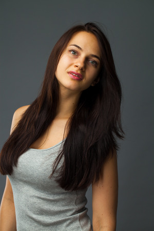 Fashion sexy brunette woman portrait. Beautiful model. Studio isolated, gray background.の写真素材