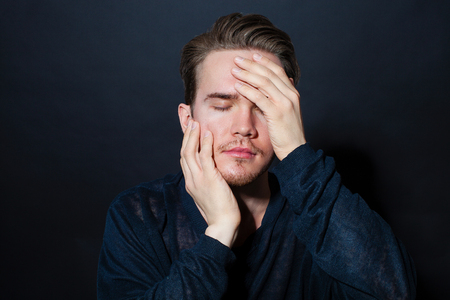 Studio portrait of a young man on a dark backgroundの写真素材