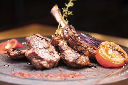 A large piece of lamb on the bone - restaurant dish - lamb grilled lamb grilled