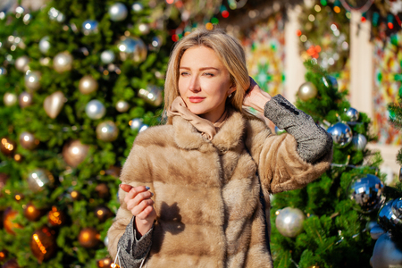 Portrait close up of young beautiful happy blonde woman in fur mink coatの写真素材