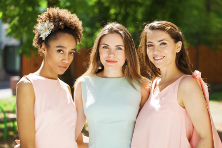 Street Fashion. Close up three beautiful happy girlfriends, summer outdoorsの写真素材