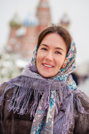 Portrait of a young woman in fur mink coat on a red square in the center of Moscowの写真素材