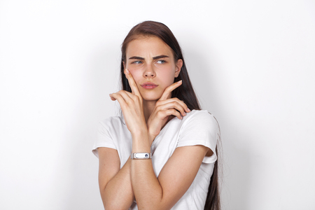 Sad brunette woman, isolated on white backgroundの写真素材