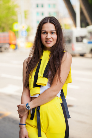 Portrait of a young beautiful tourist posing against the background of garlands on Nikolskaya street in the center of Moscowの写真素材