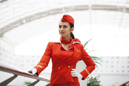 RUSSIA, MOSCOW: 28 JUNE 2019. Beautiful stewardess dressed in official red uniform of Aeroflot Airlines on airportのeditorial素材