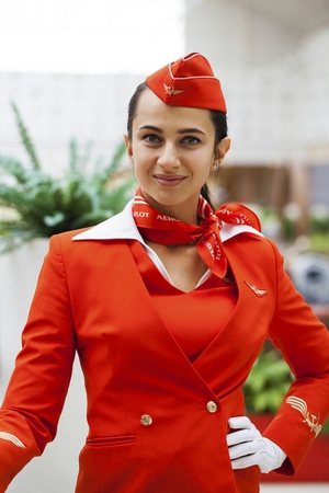 RUSSIA, MOSCOW: 28 JUNE 2019. Beautiful stewardess dressed in official red uniform of Aeroflot Airlines on airportのeditorial素材